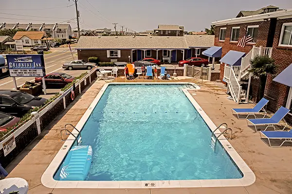 The pool seen from above, with the Colonial Inn sign and the motel around it